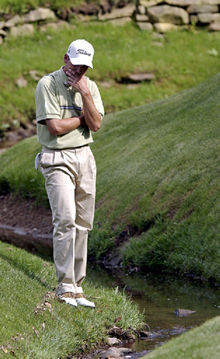 Sergio García observa su bola en el agua, en el transcurso del hoyo 13 del recorrido de ayer.