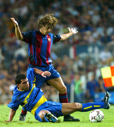 Carles Puyol evita la entrada del jugador de Boca Juniors Tevez.