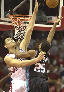 El jugador de los Rockets Yao Ming (de blanco) trata de bloquear un tiro del de los Grizzlies Earl Watson durante el partido de anoche