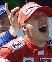 Ralf Schumacher echa champaña por la espalda de su hermano Michael en el podio del GP de Francia.