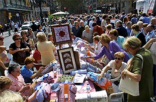 La Rambla de Barcelona se convirtió ayer en un gran taller al aire libre en el que las manos mañosas de unas 3.000  puntaires  confeccionaron puntillas a la vista de los paseantes.