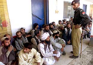 Un policía paquistaní vigila a manifestantes protalibán detenidos en la localidad de Kuchlagh, a unos 20 kilómetros de Quetta.
