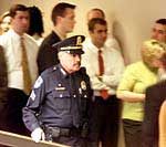 Un policía camina junto a trabajadores del Congreso de Estados Unidos, alineados para pasar un control de presencia de ántrax.rnFotos de sobres que contenían ántrax divulgadas por Washington.