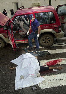 La policía investiga junto al cadáver de uno de los palestinos que ayer mató a tiros a cuatro israelíes en Hadera.