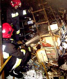 Los bomberos, ayer, en el interior del archivo de Sant Mateu tras el incendio.