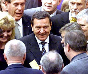 El canciller Gerhard Schröder charla con un grupo de diputados antes de la votación.