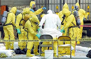 Miembros de un equipo de emergencia limpian sus trajes en la oficina postal de West Trenton en octubre.