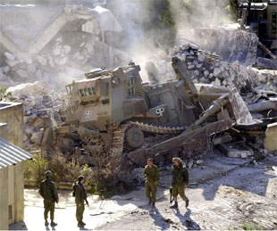 Soldados israelíes contemplan cómo un edificio de la presidencia palestina es arrasado en Ramala.