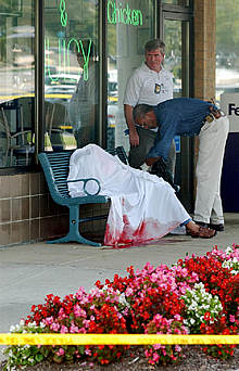 Un policía investiga el escenario en el que yace una de las víctimas en el condado de Montgomery.