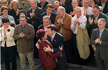 El  lehendakari  Ibarretxe abraza a María Isabel Lasa en presencia de miembros del Gobierno vasco.