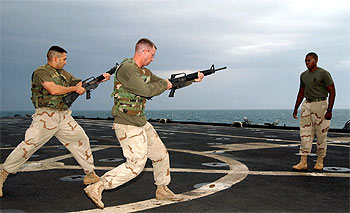 Los   marines   estadounidenses Angel Salcedo y Johnny Piles entrenan en la cubierta del buque   USS     Austin,   en aguas del Golfo Pérsico.