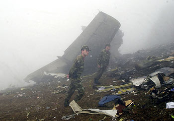 Dos soldados turcos inspeccionan los restos del Yak-42.