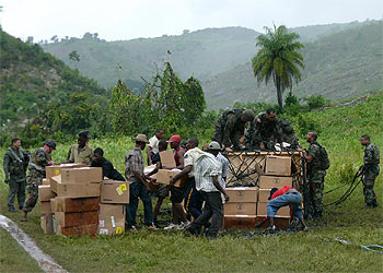 Marines  estadounidenses y residentes locales descargan ayuda humanitaria en Mapou, 50 kilómetros al sureste de Puerto Príncipe (Haití).