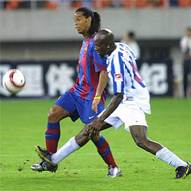 Ronaldinho supera la acometida de Kola.