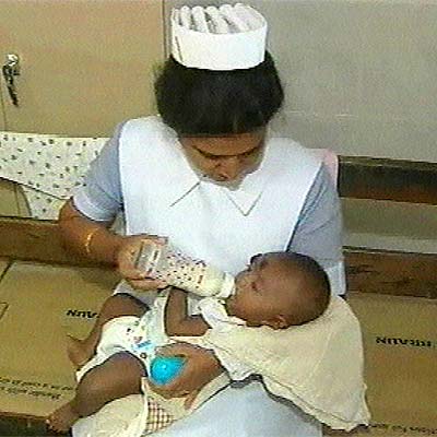 Una enfermera da el biberón al  Baby 81  en el hospital de Kalmunai.