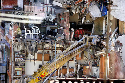 La demolición del edificio número 10 del pasaje Calafell, adjunto al socavón que se tragó un garaje el jueves pasado, puso al descubierto el interior de las viviendas.