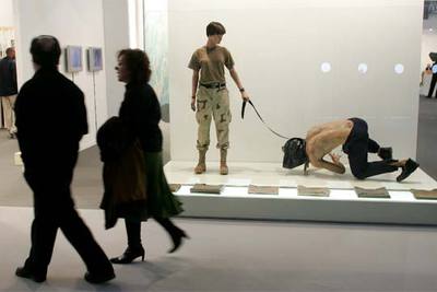 Dos visitantes ante  El perro de Democracy 2005,  de Pablo España, Iván López y Ramón Mateos.