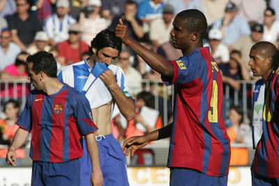 Eto'o hace un gesto en presencia de Giuly y Fernando Sanz.