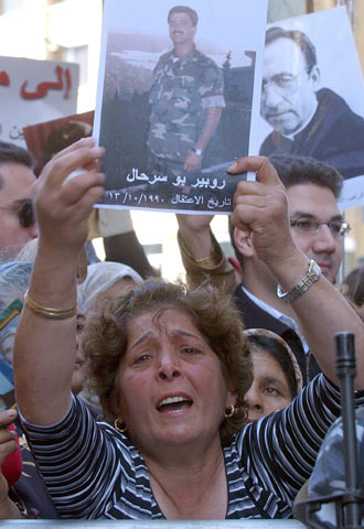 Una mujer libanesa muestra una fotografía de un familiar preso en Siria.