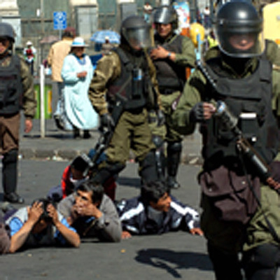 Agentes antidisturbios detienen a participantes en una manifestación ayer en la capital de Bolivia.