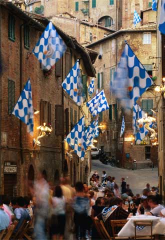 Banquete callejero en Siena antes del Palio, la legendaria carrera de caballos urbana programada el 16 de agosto.
