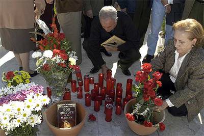 Una mujer  coloca unas flores ante la fosa común del cementerio de San Eufrasio, en Jaén.
