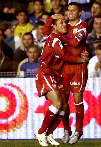 Adriano (izquierda) y Saviola se abrazan tras el gol de este último.