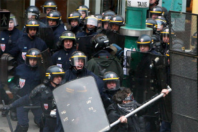Un grupo de policías antidisturbios carga contra un manifestante armado con una barra, ayer en París.