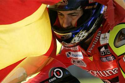 Jorge Lorenzo, enfundado con la bandera española, celebra su triunfo.