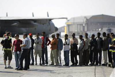 Los  sin papeles  rescatados por el pesquero  Francisco y Catalina  esperan en el aeropuerto de La Valeta para embarcar en los aviones militares españoles.