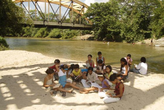 Niños y adolescentes de Aracataca leen a García Márquez junto al río, contiguo a la mítica fábrica del hielo