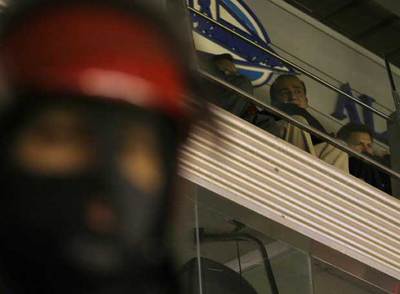 Un   ertzaina   protege el palco, desde donde sigue el partido Piterman.