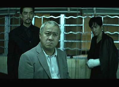 En primer plano, el actor Eric Tsang, en un fotograma de  Infernal affairs. 