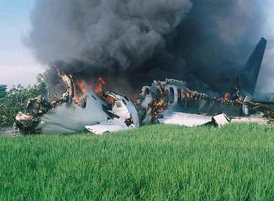 Los restos del avión siniestrado, envueltos en humo tras el incendio que sufrió al realizar un brusco aterrizaje en el aeropuerto de Yogyakarta.