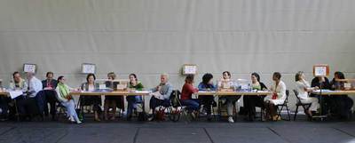 Integrantes de mesas electorales de un colegio de Madrid, a la espera de que los electores acudan a depositar la papeleta.