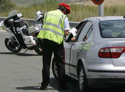 Un  ertzaina  para a un automovilista en un control de velocidad.
