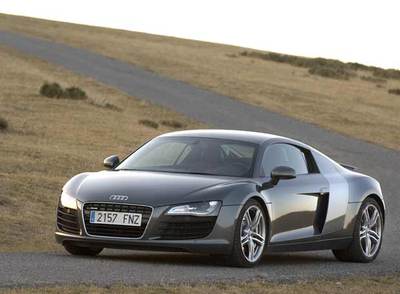 El Audi R8 prescinde de accesorios aerodinámicos para ofrecer una imagen más discreta y elegante que otros superdeportivos. La banda vertical   sideblade   del lateral separa la mecánica del habitáculo.