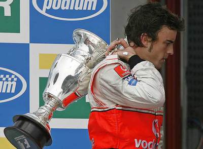 Fernando Alonso se retira del podio con el trofeo de tercer clasificado en Brasil.