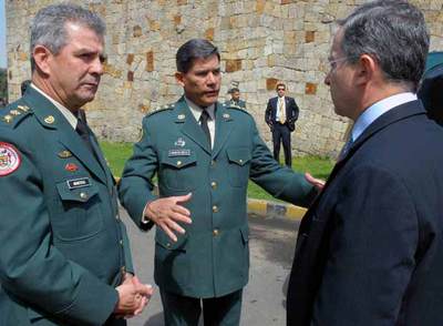 El presidente colombiano, Álvaro Uribe, conversa con dos altos mandos militares en Bogotá.