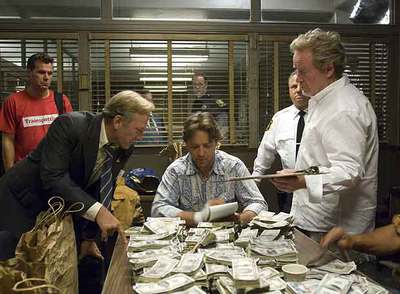Ridley Scott, a la derecha, da indicaciones a Russell Crowe, sentado, en el plató de  American gangster. 