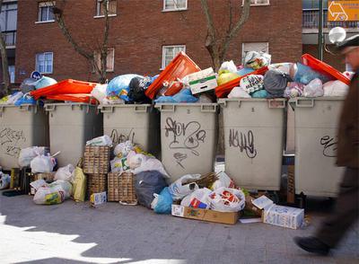 Las basuras se acumulan en varios contenedores de la calle de San Dámaso, al lado del Manzanares.