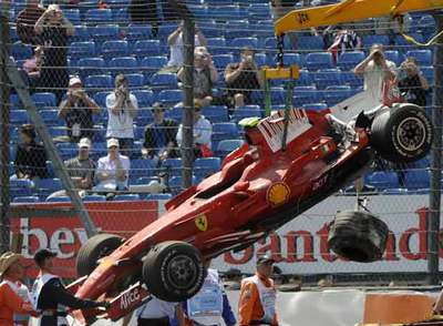Una grúa retira el monoplaza de Massa accidentado en el circuito de Silverstone.