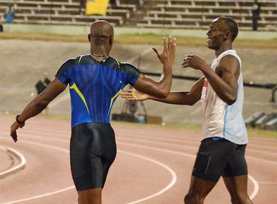 Asafa Powell, a la izquierda, saluda a Usain Bolt tras su enfrentamiento de junio en Jamaica.