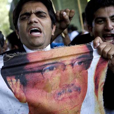 Un abogado rasga un cartel de Zardari en una protesta, en Islamabad.