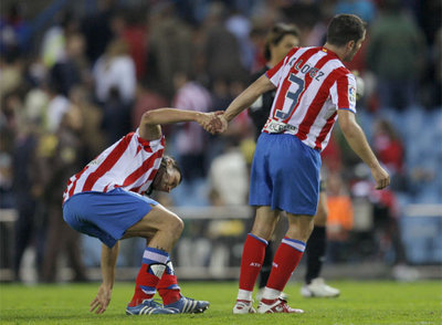 Antonio López ayuda a levantarse a Ujfalusi en un partido de Liga.