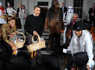 Barack Obama y su esposa, Michelle, reparten dulces en la noche de Halloween.