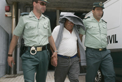 El armador vigués Jesús Obral, escoltado por la Guardia Civil a la salida del juzgado de Cambados, antes de ingresar en prisión.rnUno de los detenidos se cubre el rostro al llegar al juzgado.