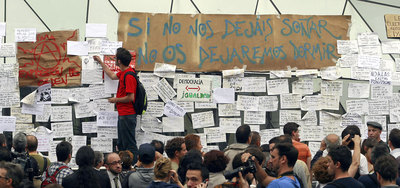 Jóvenes integrantes del Movimiento 15-M colocan mensajes en los paneles instalados en el  kilómetro cero  de la Puerta del Sol.