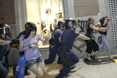 La policía carga contra manifestantes laicos en la calle de Carretas de Madrid, anoche.