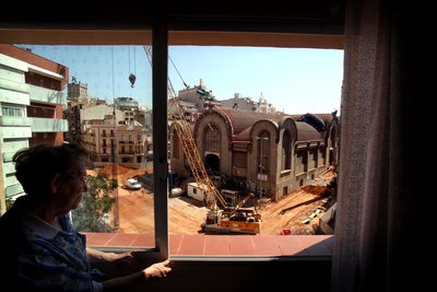 Una vecina cierra la ventana ante el ruido y el polvo de las obras en el Mercat Central de Tarragona.